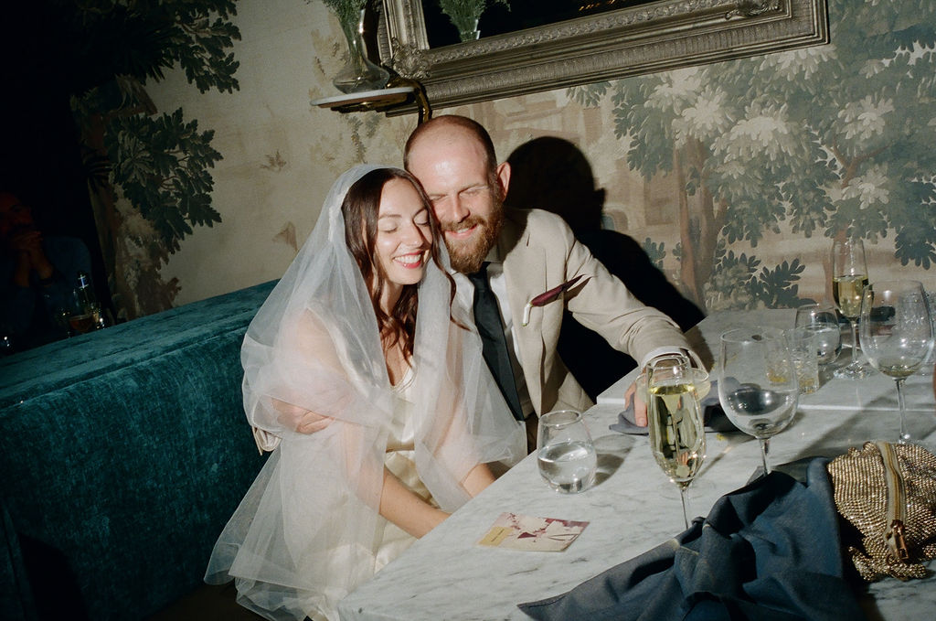 A married couple with eyes closed, enjoying a quiet and happy moment together.
