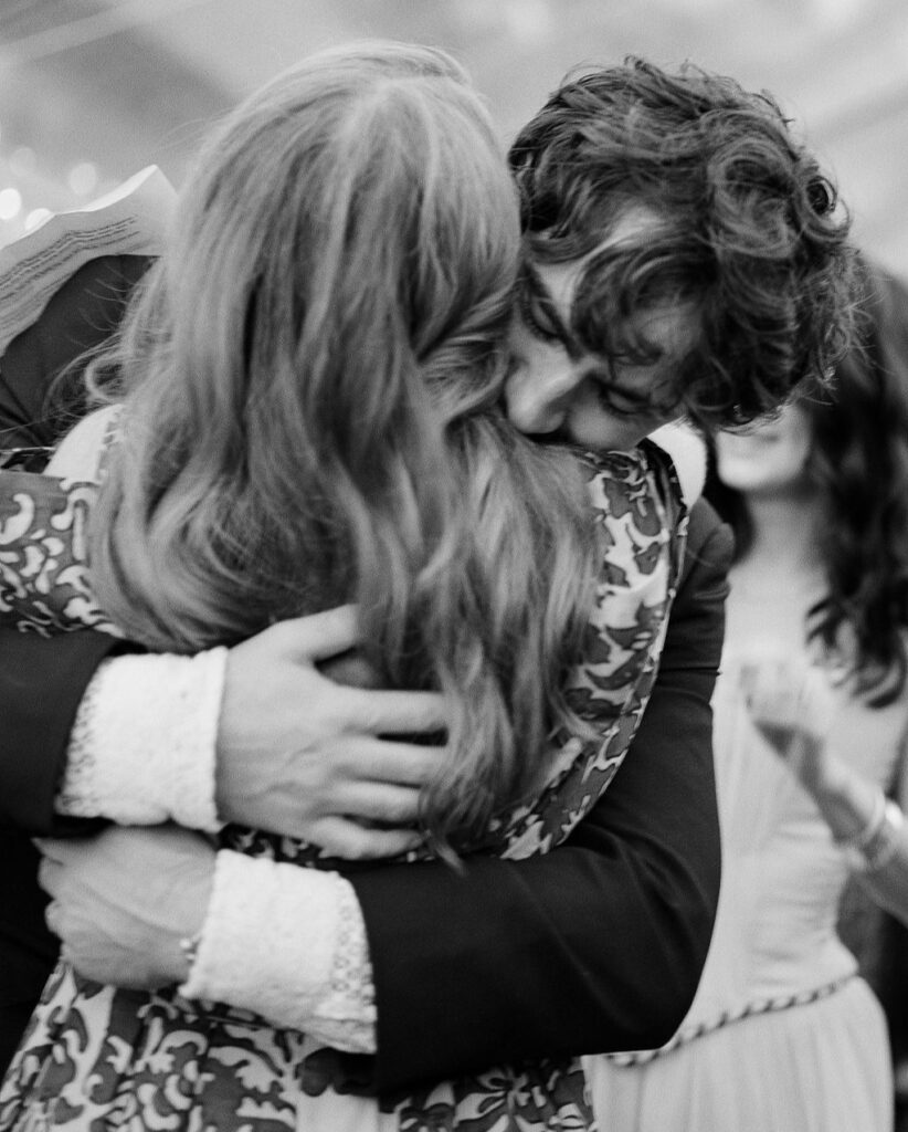 A couple embracing, sharing a quiet and affectionate moment together.